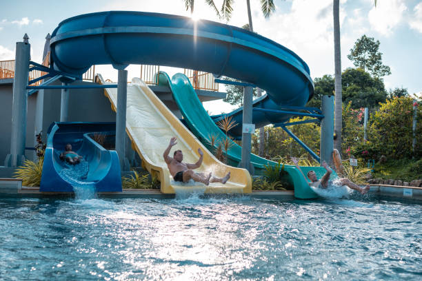 istock Friends enjoying on slides at water park 982826910