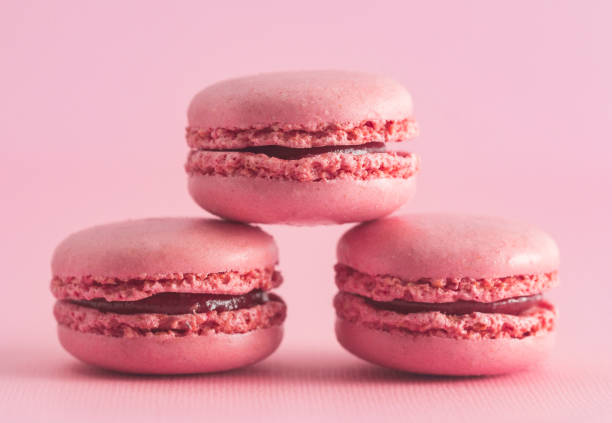 istock Pink French Macarons on a Pink Background 982833940