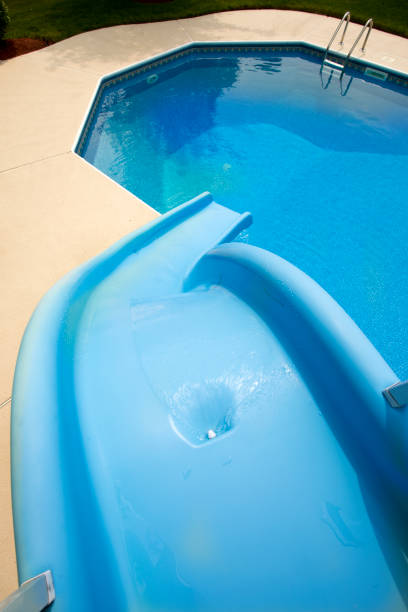 Top of the water slide Top view of slide looking down in to pool. Image shot with Canon 5D Mark lV, 24-105mm f/4L IS USM lens. top of water slide photos stock pictures, royalty-free photos & images