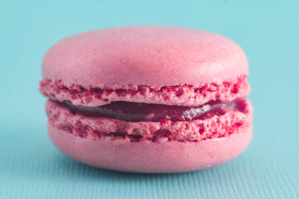 istock Pink French Macarons on a Blue Background 982837094