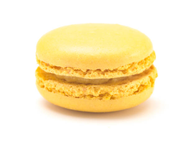 istock Single Yellow French Macarons on a White Background 982842212
