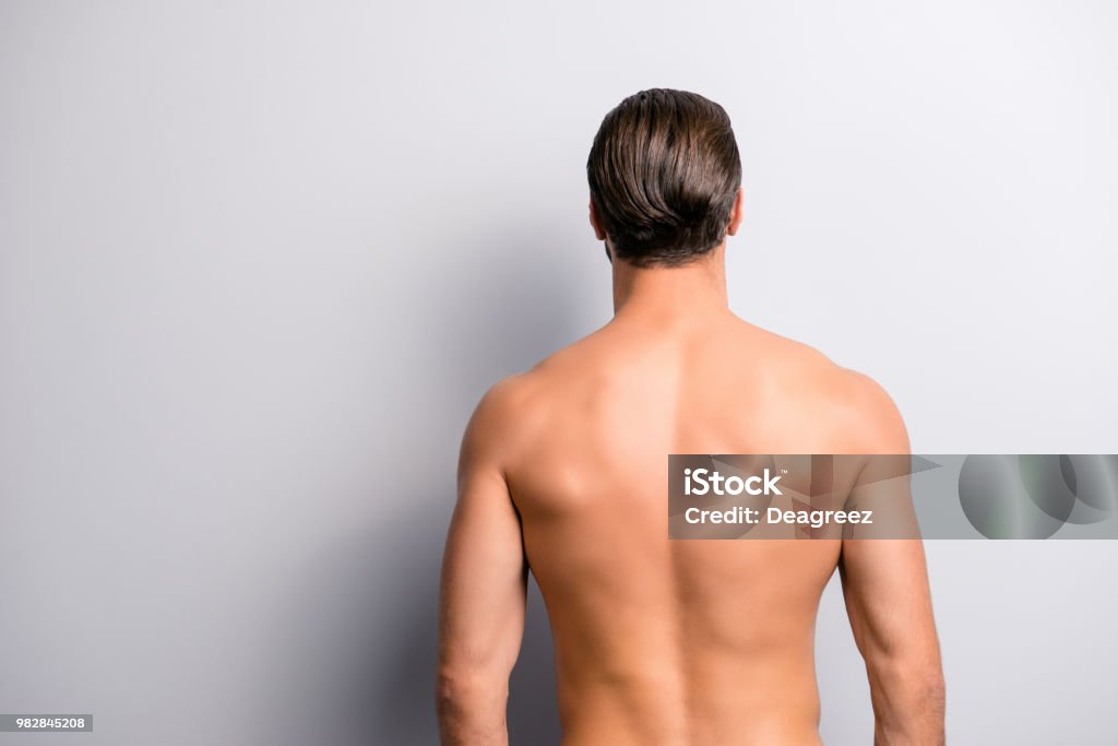 Rear back behind view photo of strong muscular handsome attractive stunning confident ideal perfect sportsman isolated on gray background copyspace Rear View Stock Photo