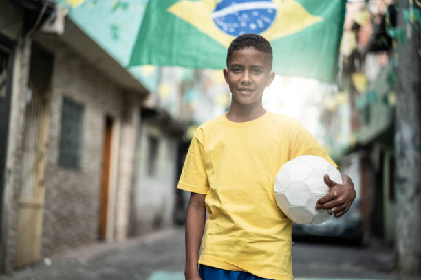 istock Brazilian Kid Playing Soccer Portrait 982846176