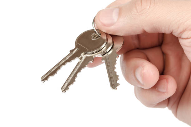 istock Keys from the lock in hand on white background. 982856672