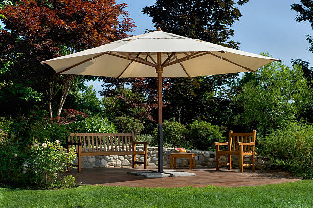 istock Parasol in a garden with wooden bench and chairs 98287885