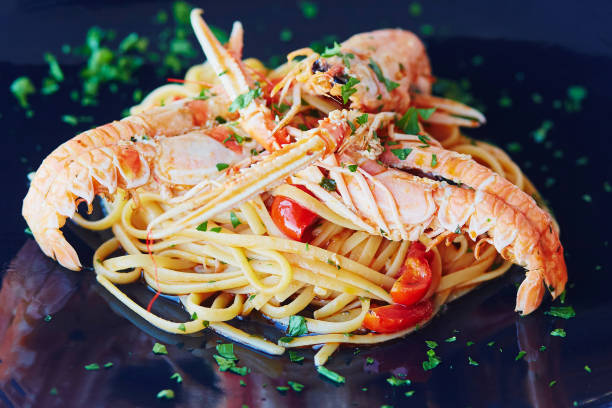 istock Delicious pasta with lobsters, vegetables and sauce 982888048