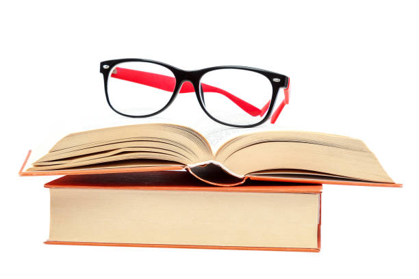 istock Open book and glasses on a stack of books 982895806