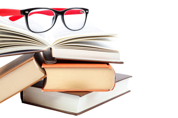 istock Open book and glasses on a stack of books 982896102