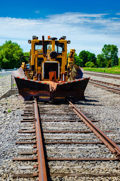 istock Rusty vintage railway snowplow parked on an unused rail siding. 982898550
