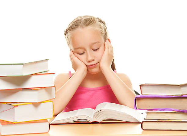 istock Young schoolgirl reading a book 98290437