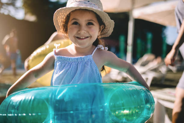istock Cute child with a blue swimming ring 982904542