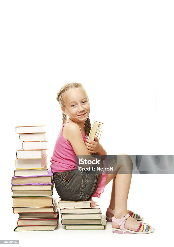 Little Aluna sentado sobre uma pilha de livros - Foto de stock de Adolescente royalty-free