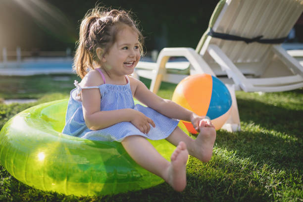 istock Cute little toddler smiling by the pool 982907580