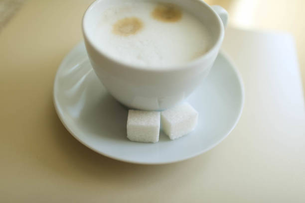 Cup of cappuccino on the table, coffee shop background. Marble texture. Close up
