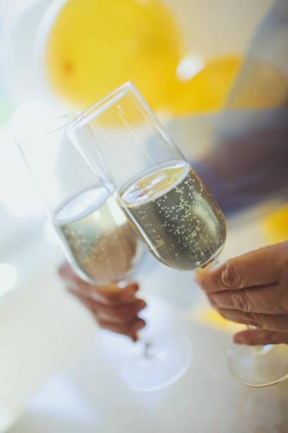 istock Pouring champagne in flutes standing on table 982913546