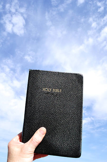 istock Hand Lifting Holy Bible to the Sky 98291385