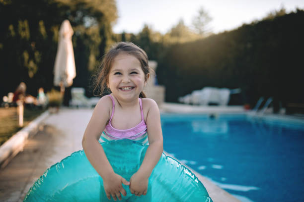 istock Cute smiling girl ready for a swim 982922974