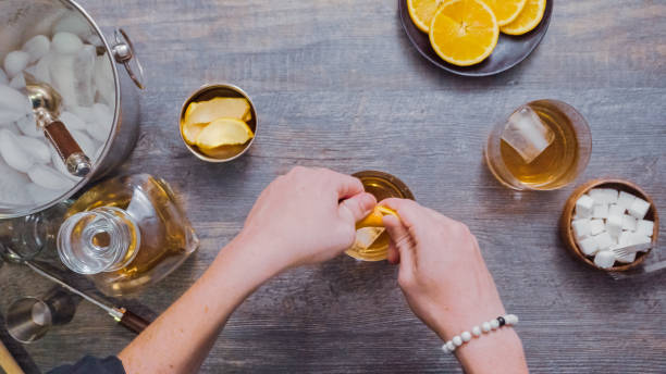 istock Preparing Bourbon old fashioned cocktail at home bar. 982943874