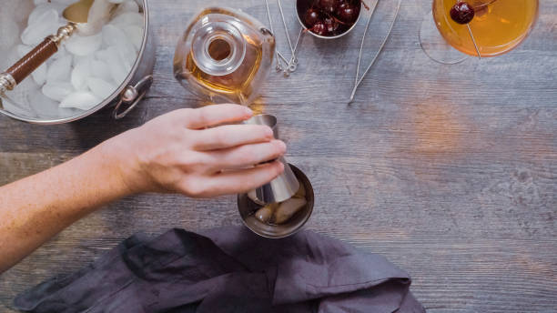 istock Preparing Manhattan cocktail at home bar. 982944818