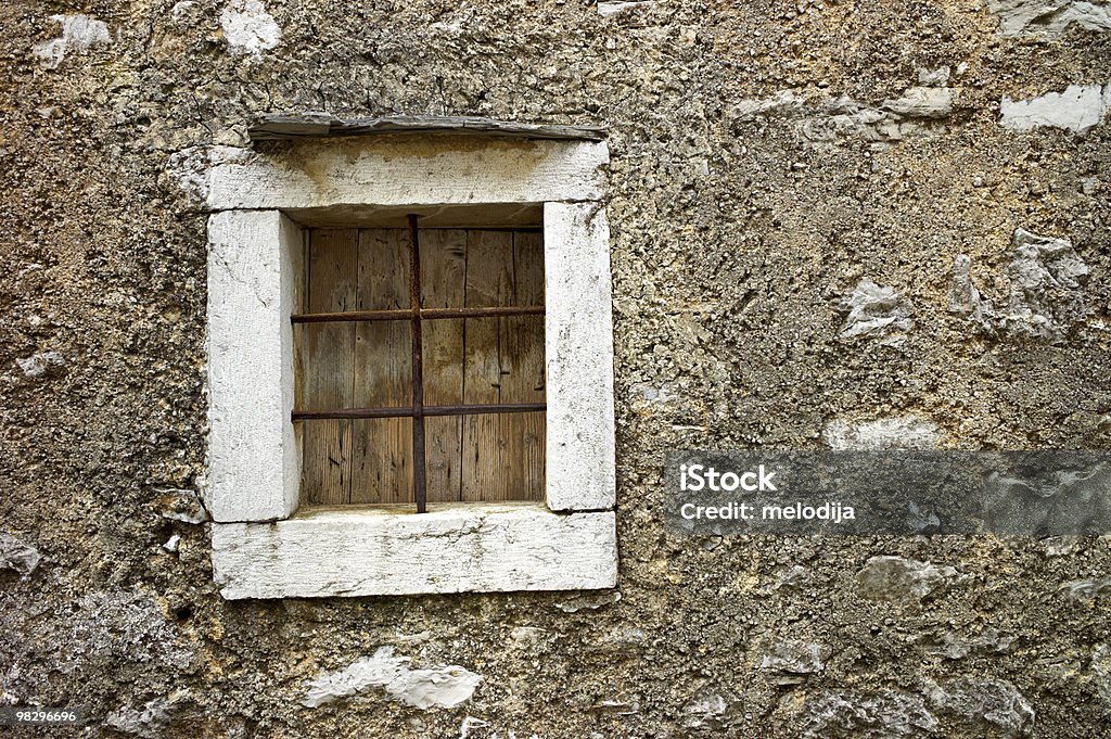 Stone window with iron  Brick Wall Stock Photo