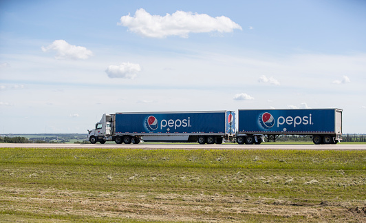 A Pepsi truck hauling cargo down a highway. Taken in Red Deer, Alberta