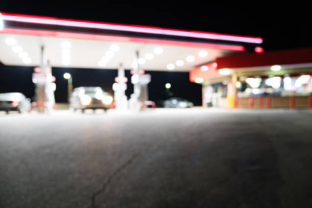 istock Abstract blurred gas station with car refueling at night 983026978