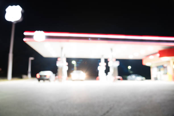istock Abstract blurred gas station with car refueling at night 983027044