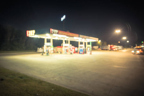 istock Vintage blurred gas station with car refueling at night 983030696