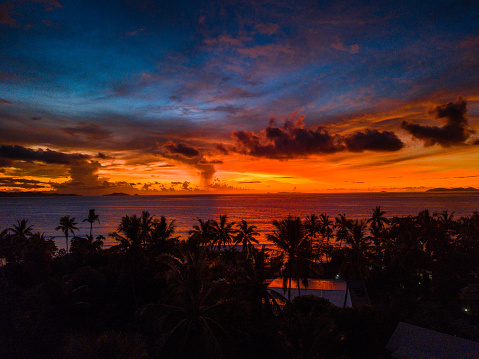 Another day begins in the Caribbean and the sunrise illuminates the clouds on the horizon.