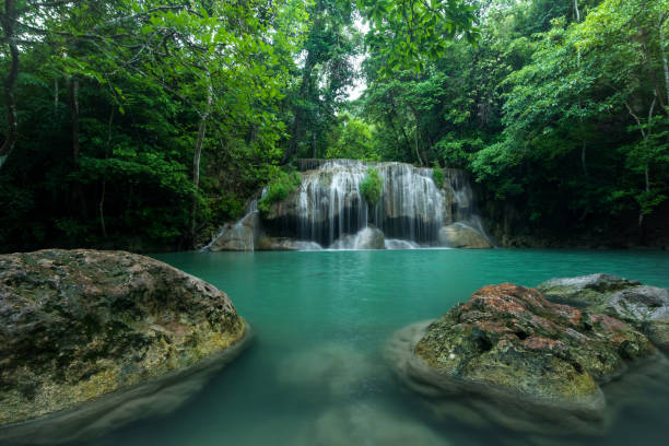 istock Breathtaking green waterfall at deep forest, Erawan waterfall located Kanchanaburi Province, Thailand 983046108