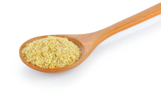 istock Wheat germ in wood spoon on white background 983062326