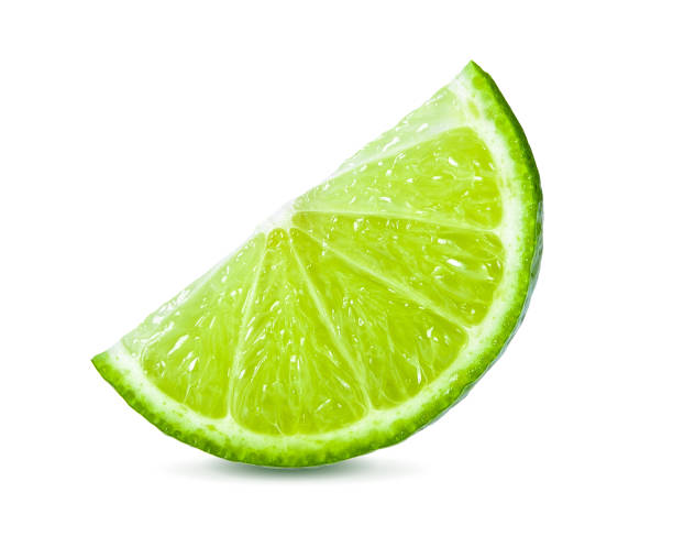 istock Juicy slice of lime isolated on white background 983075288