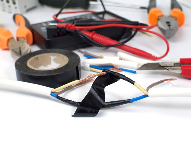 istock insulating electrical wire connection with black electric tape, shallow depth of field 983075728