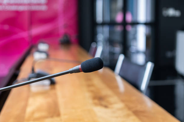 istock Microphone over the blurred business forum Meeting or Conference Training Learning Coaching Room Concept, Blurred background 983098920