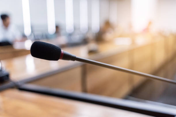 istock Microphone over the blurred business forum Meeting or Conference Training Learning Coaching Room Concept, Blurred background 983099030
