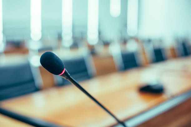 istock Microphone over the blurred business forum Meeting or Conference Training Learning Coaching Room Concept, Blurred background 983099044