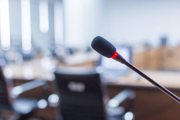 istock Microphone over the blurred business forum Meeting or Conference Training Learning Coaching Room Concept, Blurred background 983099186