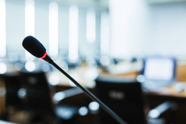 istock Microphone over the blurred business forum Meeting or Conference Training Learning Coaching Room Concept, Blurred background 983099198