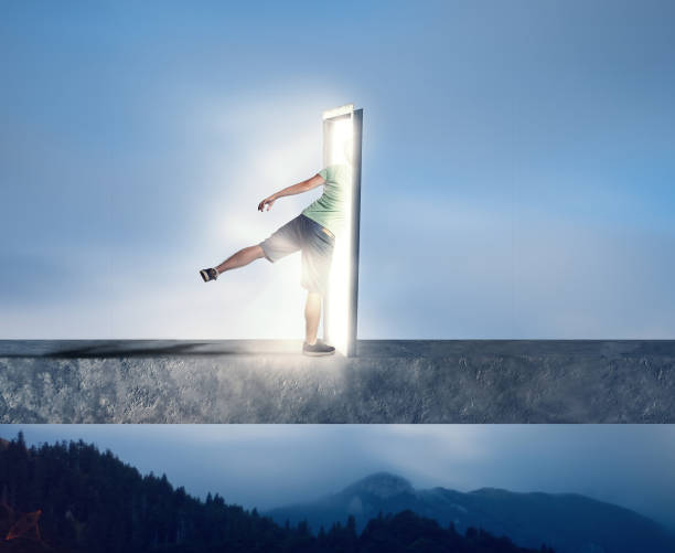 istock Man goes through a door portal. 983112518