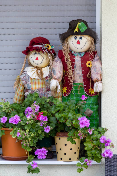 istock Two decorative dolls and flowerpots in the yard. Hungary 983115430