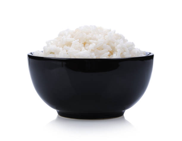 istock rice in black bowl on white background 983120122