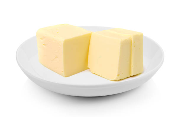 istock Stick of butter in a plate on white background 983123902