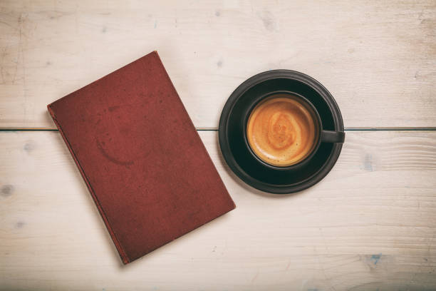 istock Old book and a cup of coffee 983124438