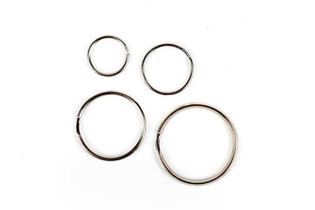 istock Silver key rings of different sizes isolated on a white background 983133838