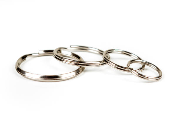 istock Silver key rings of different sizes isolated on a white background 983138102