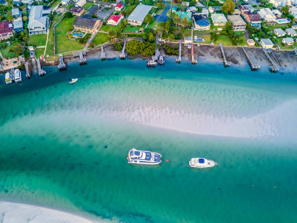 istock Two boats moored in the channel with sand bars patterns 983138314