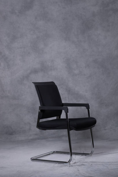 istock A chair in front of a tie dye pattern abstract background 983138394