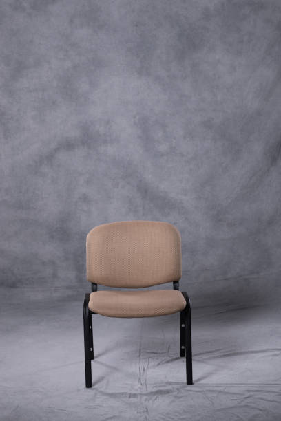 A chair in front of a tie dye pattern abstract background