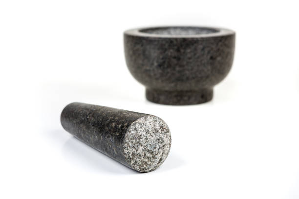 istock Heavy black stone mortar and pestle isolated on a white background 983138574