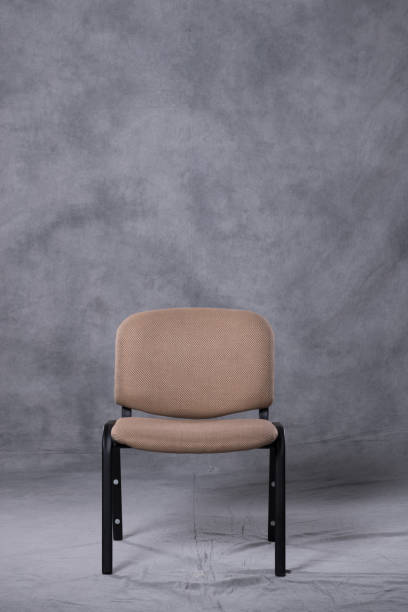 istock A chair in front of a tie dye pattern abstract background 983138758